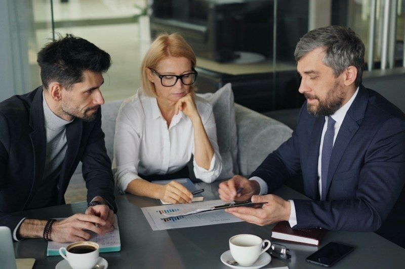 Advisors reviewing an investment report with a client